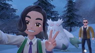 Pokemon trainers taking a selfie with Abomasnow in Pokemon Scarlet and Violet.