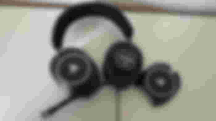 A black, over-ear, PlayStation-branded RIG wired headset with mic sticking out.